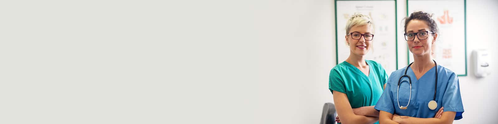 two rehab therapists standing with their arms crossed in the rehab gym