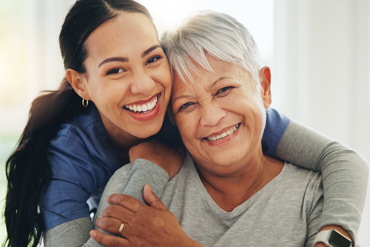 nurse hugging senior patient