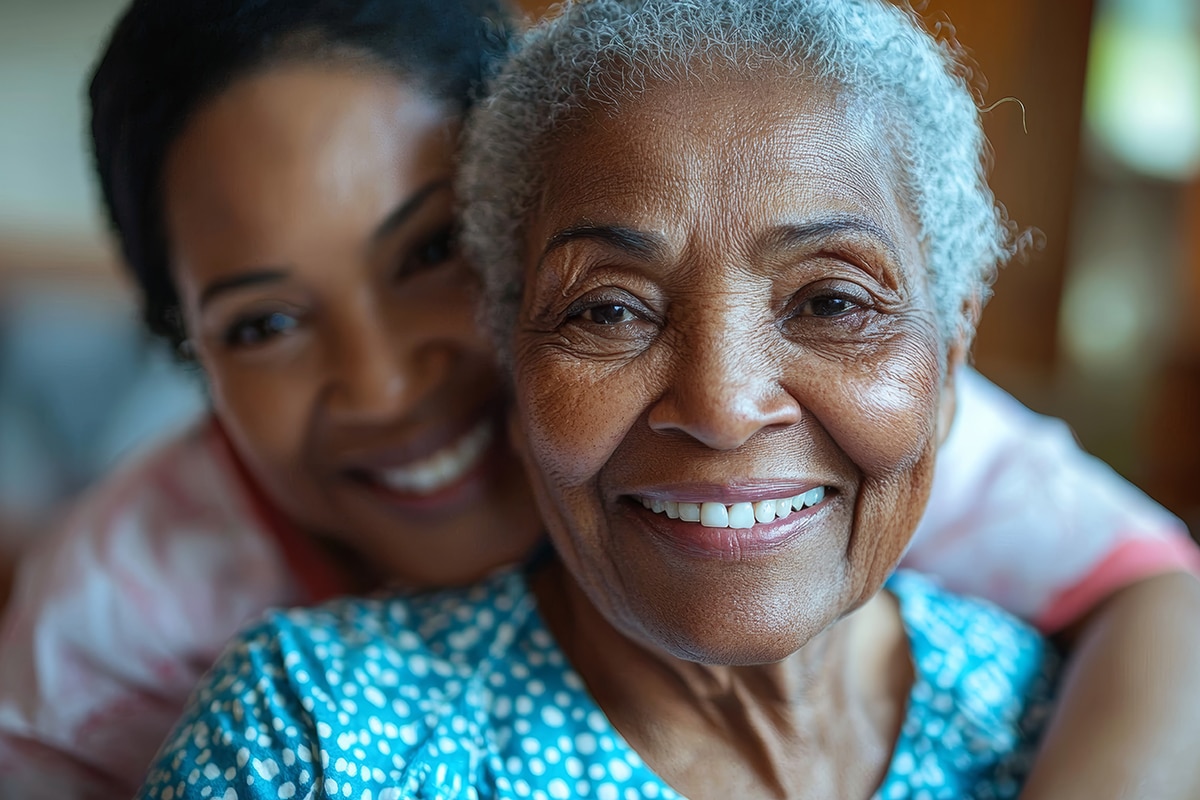 Happy senior woman being hugged by her daughter