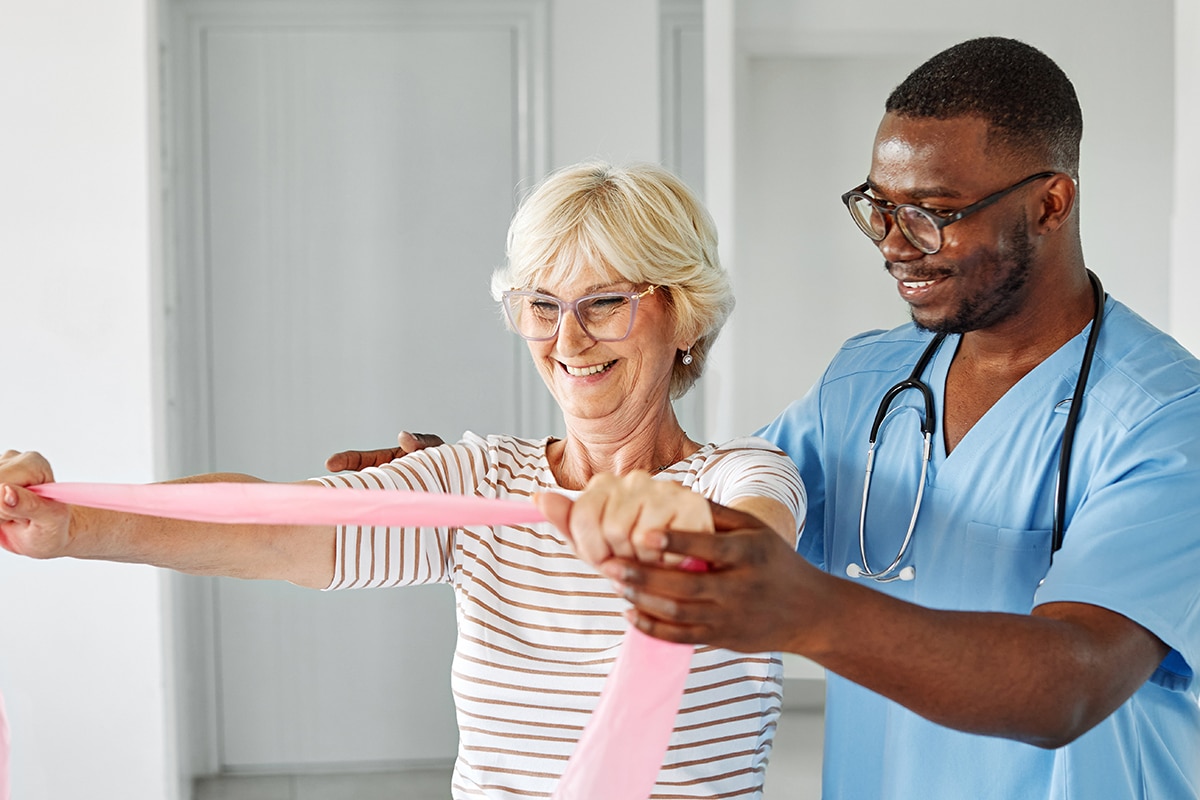 therapist and senior  woman exercising